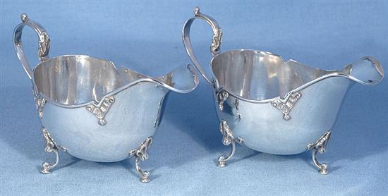 A cased pair of George V silver sauce boats, by Walker & Hall, Length 161mm weight 9.5oz/296grms